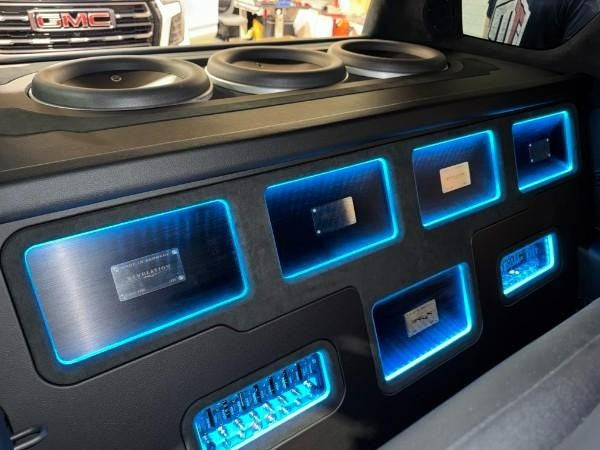 Professional car audio installation in an SUV featuring a BRAX 12-channel DSP, BRAX amplifiers, and JL Audio subwoofers tuned by Total Tuning.